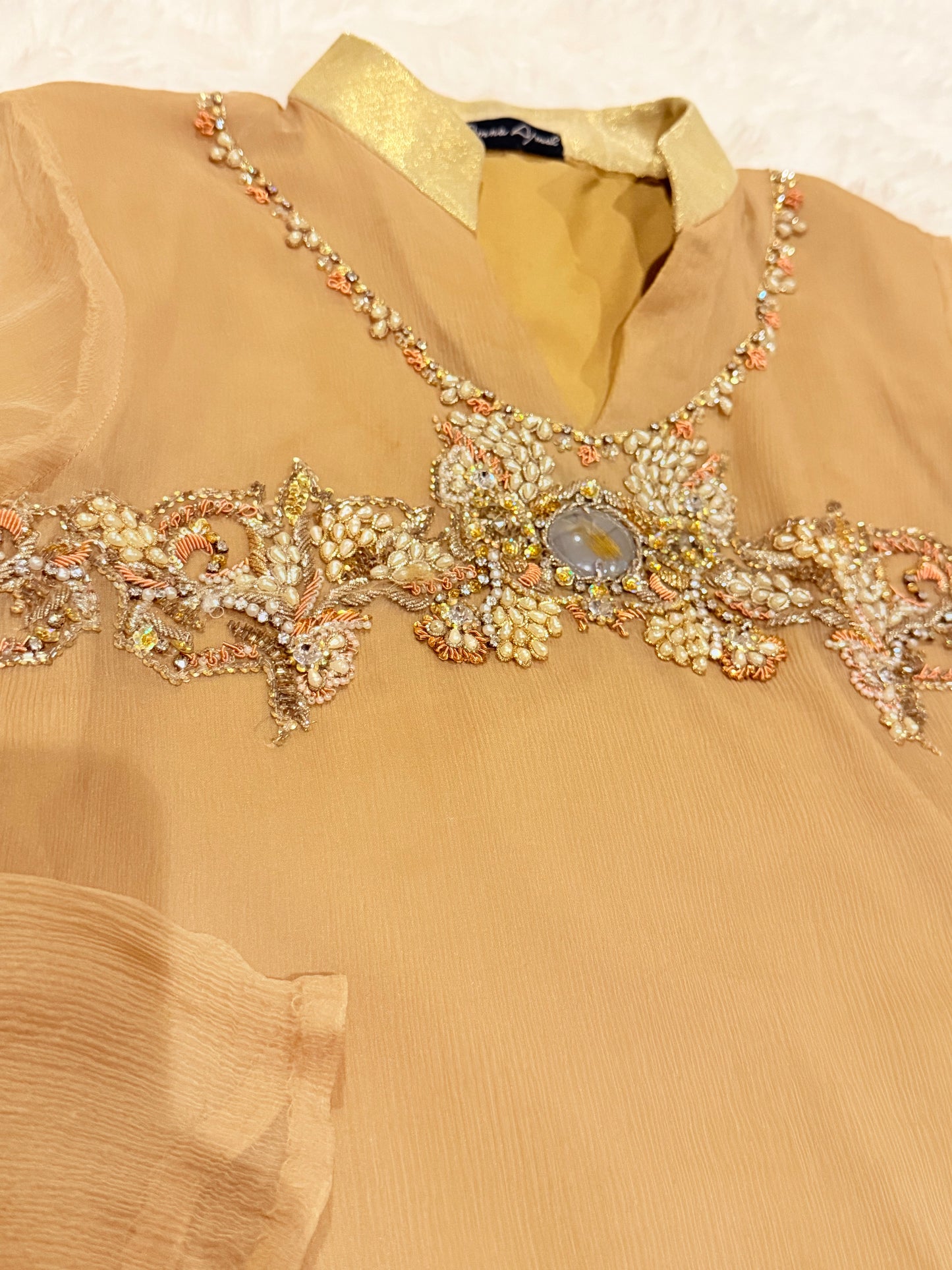 Amna Ajmal Couture Chiffon Lux Shirt in Beige color with heavy stone embellishments, comes with matching wide leg trouser in silk