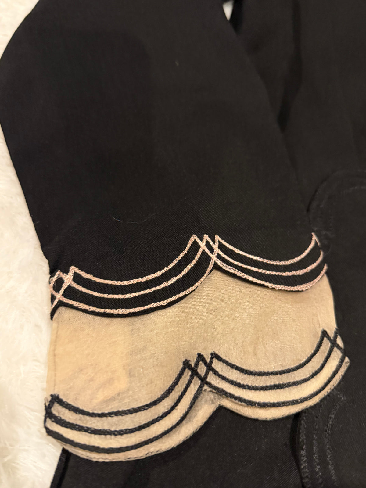 Asifa & Nabeel Long Black Shirt with Assymetric Hemline, Embroidery on front Hem and organza edged sleeves. Lovely floral embroidery near neckline