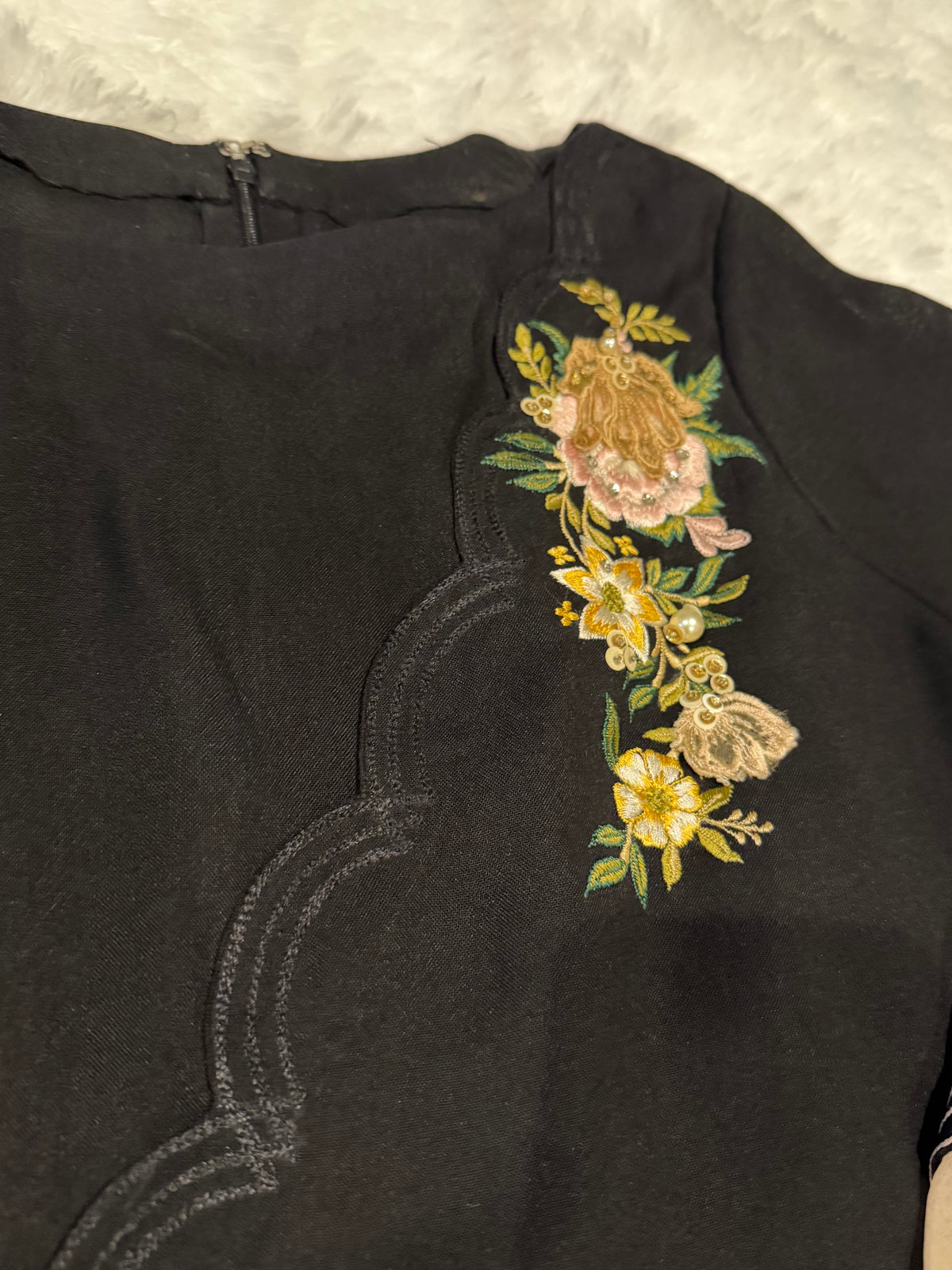 Asifa & Nabeel Long Black Shirt with Assymetric Hemline, Embroidery on front Hem and organza edged sleeves. Lovely floral embroidery near neckline