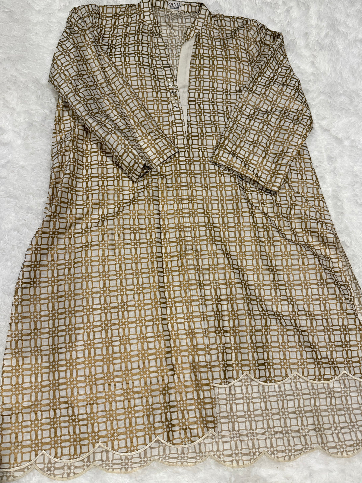 Sania Maskatiya Silk Block Printed Kurta style shirt with different front hem length and signature Sania embellishments on neckline.