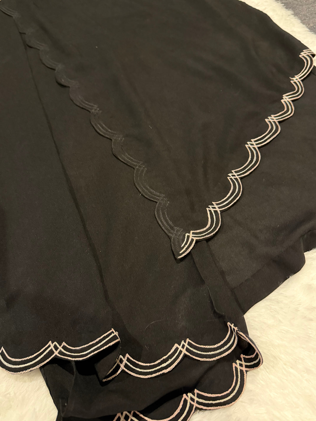Asifa & Nabeel Long Black Shirt with Assymetric Hemline, Embroidery on front Hem and organza edged sleeves. Lovely floral embroidery near neckline