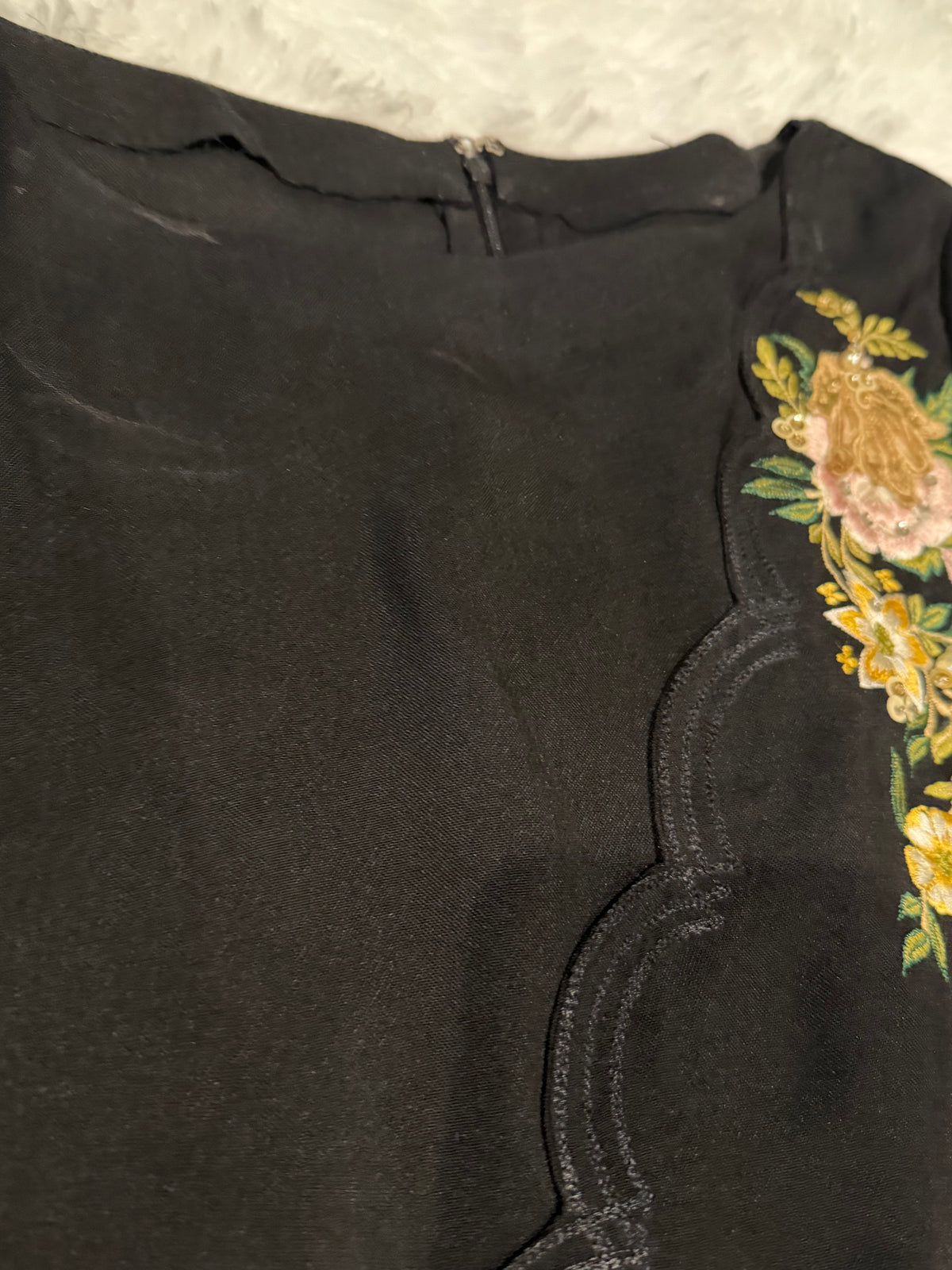 Asifa & Nabeel Long Black Shirt with Assymetric Hemline, Embroidery on front Hem and organza edged sleeves. Lovely floral embroidery near neckline