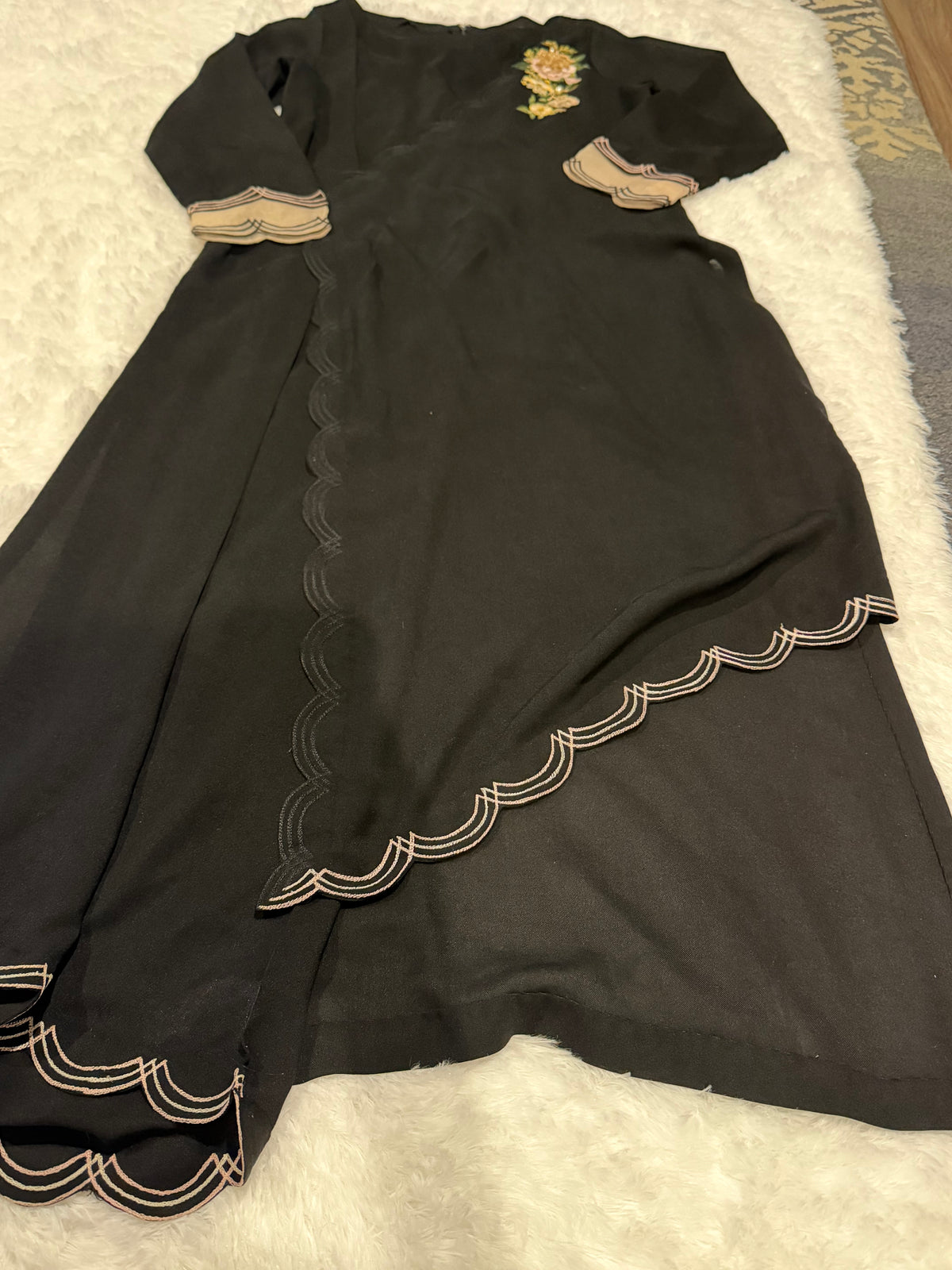 Asifa & Nabeel Long Black Shirt with Assymetric Hemline, Embroidery on front Hem and organza edged sleeves. Lovely floral embroidery near neckline